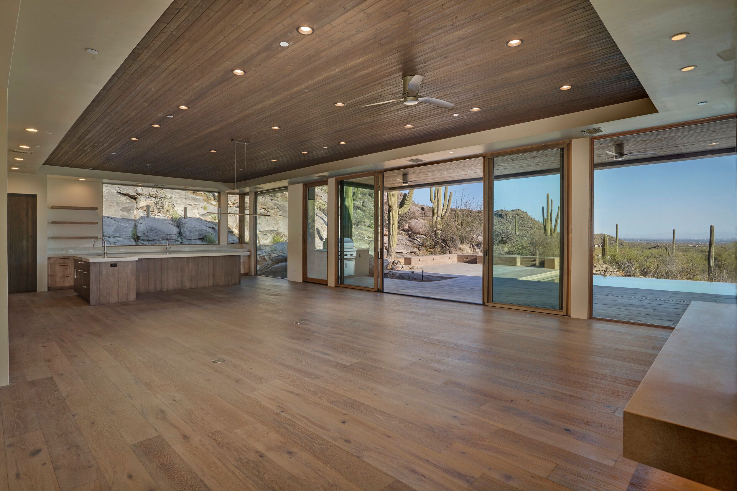 Great room with sliding glass doors opening to the pool terrace and desert