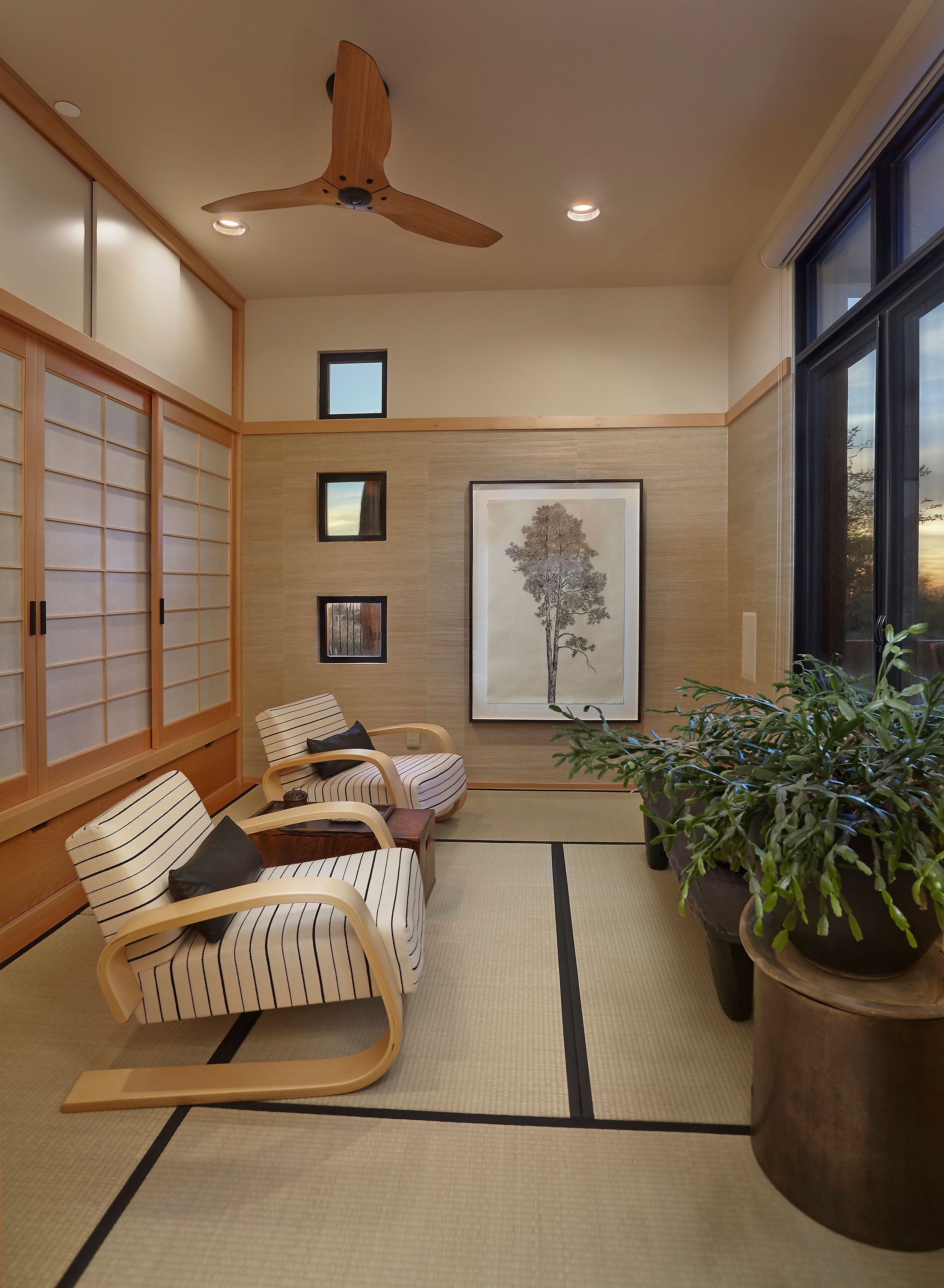 Japanese-inspired tatami room with shoji screens and bentwood lounge chairs