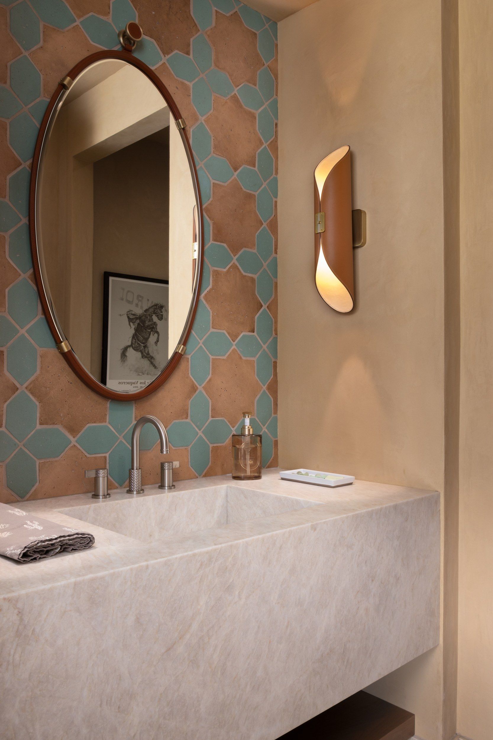 Powder room with a stone trough sink and turquoise and terracotta tile